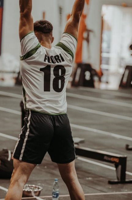 Athletes competing fiercely in an indoor gym, showcasing strength and determination.